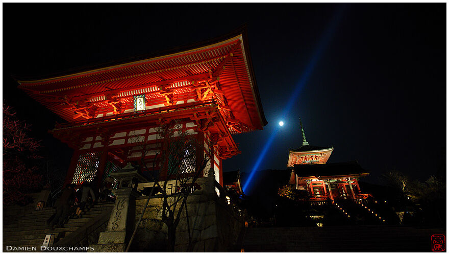 Front gate and pagoda with blue light beam and moon in Kiyomizudera