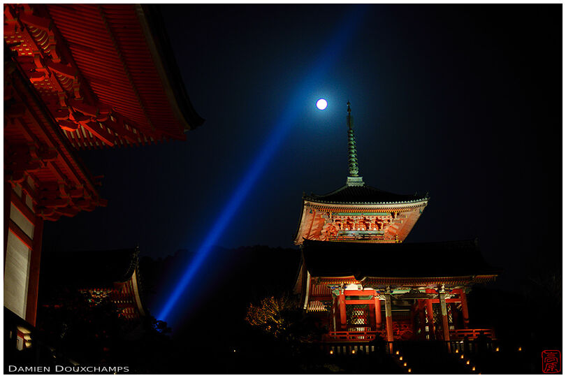 Blue light beam and moon over red pagoda in Kiyomizudera