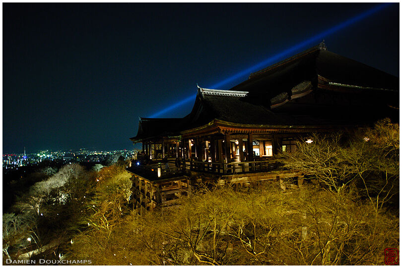 Blue projector beam over Kiyomizu-dera at night, Kyoto, Japan