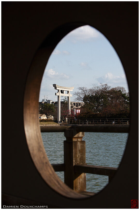 The shrine entrance torii viewed through a round window, Nagaoka-tenmangu