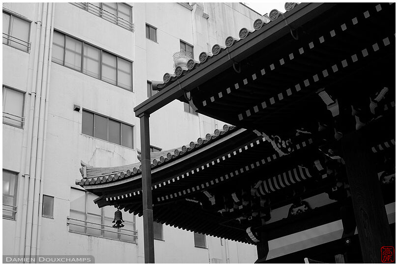 Traditional temple roof lines and ugly modern building, Honno-ji temple, Kyoto, Japan