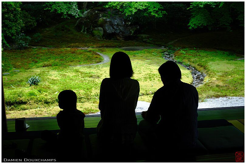Family meditating in front of moss garden, Ruriko-in temple