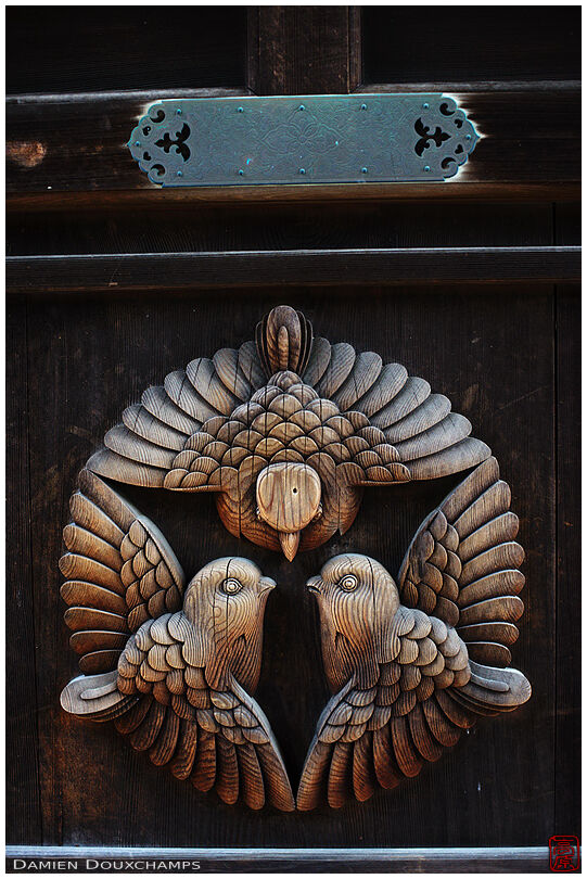 Wooden bird sculpture on temple door, Saikyo-ji