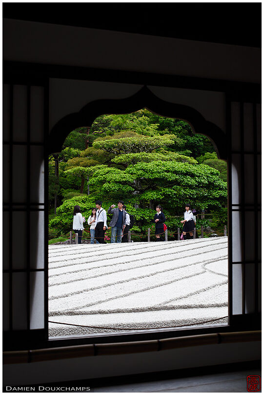 Window on tourists visiting Ginkaku-ji temple's zen gardens