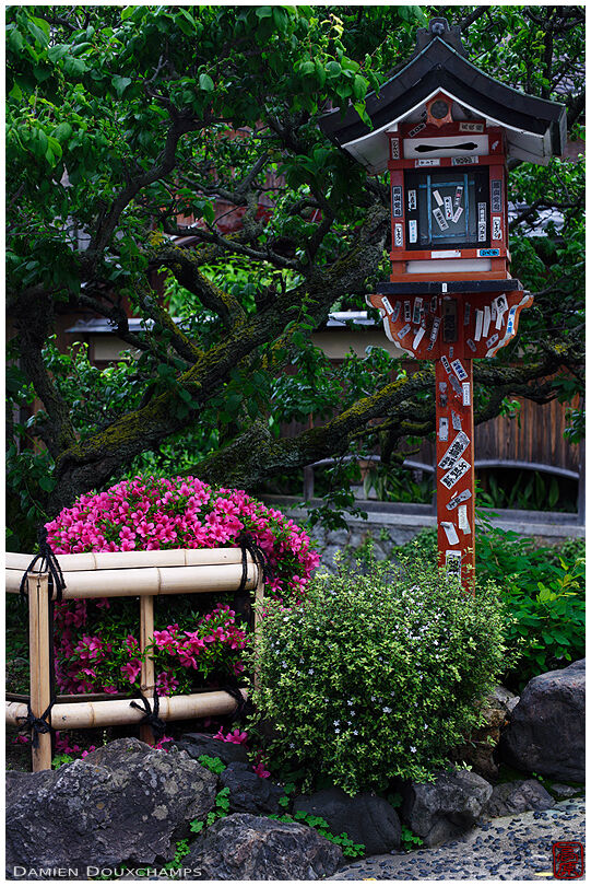 Shrine lantern with pilgrim stickers, Gion