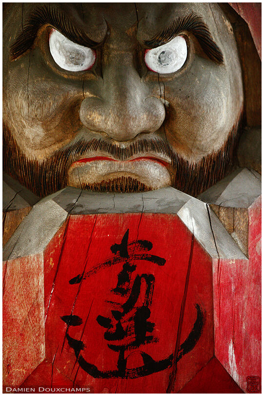 Angry-looking wooden Daruma doll