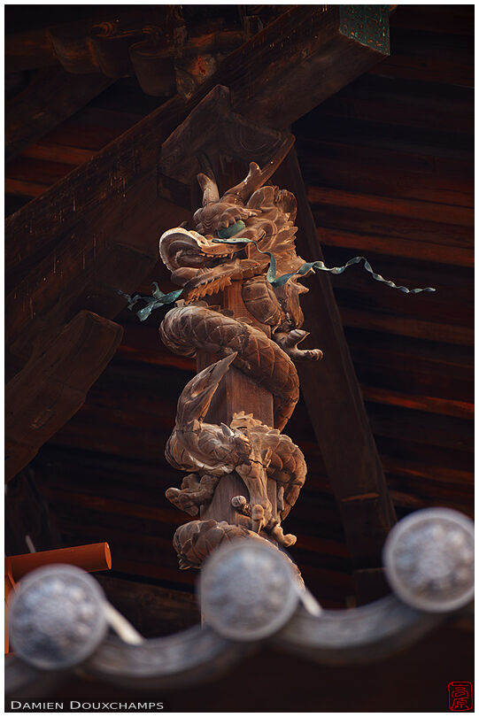Wooden dragon sculpture around pillar, Horyu-ji temple, Nara, Japan