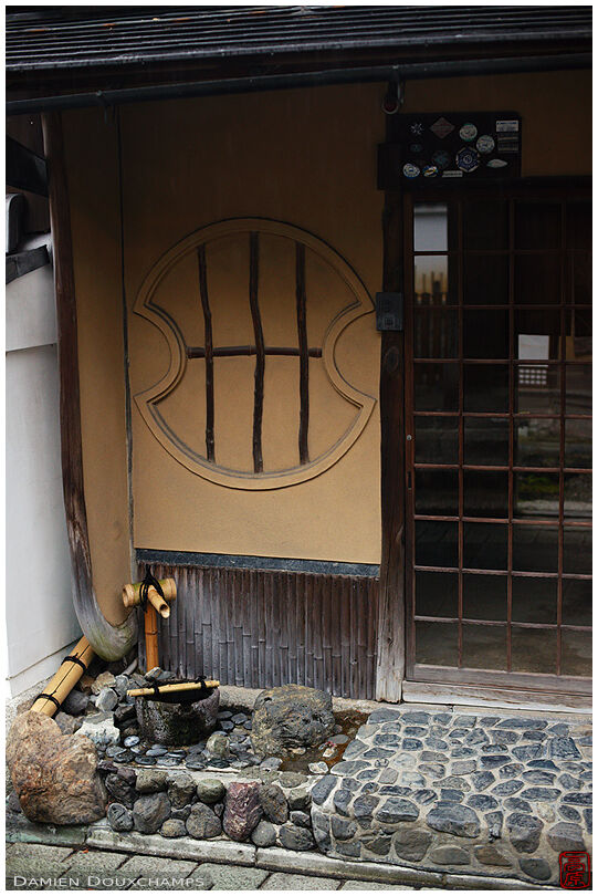 Tsukubai water basin in front of an old house in Gion