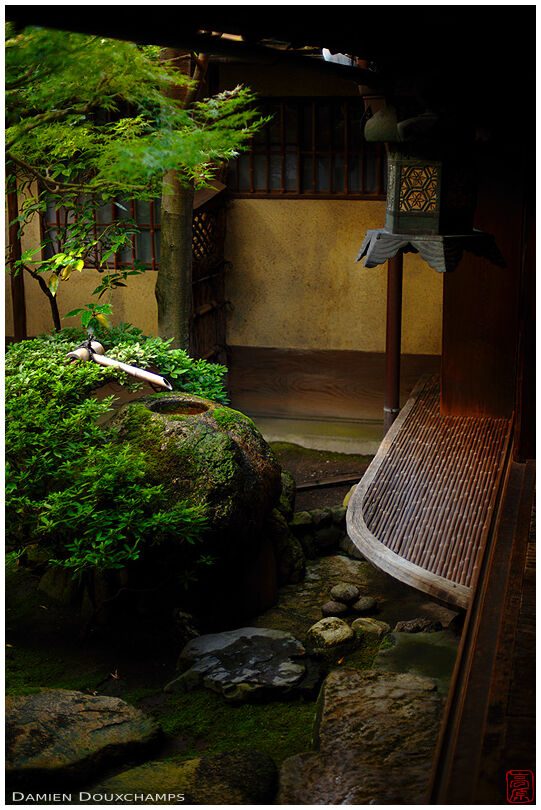 Metallic lantern and tsukubai water basin in inner garden, Sumiya house