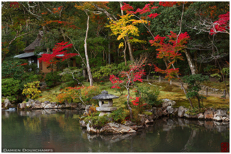 Pond with stone lantern and autumn colours, Isui-en gardens,