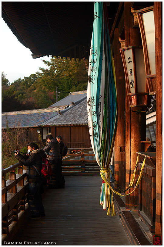 Visitors enjoying the last light on Nigatsu-do temple's terrace
