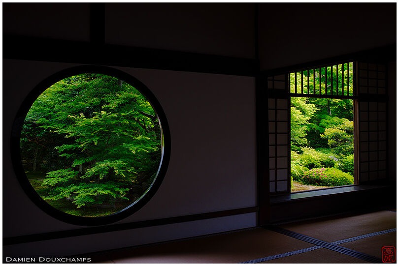 New green leaves through the round and square windows of Genko-an temple, Kyoto, Japan