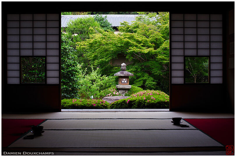 Green garden with stone lantern and pink azalea from tea room, Unryu-in temple, Kyoto, Japan