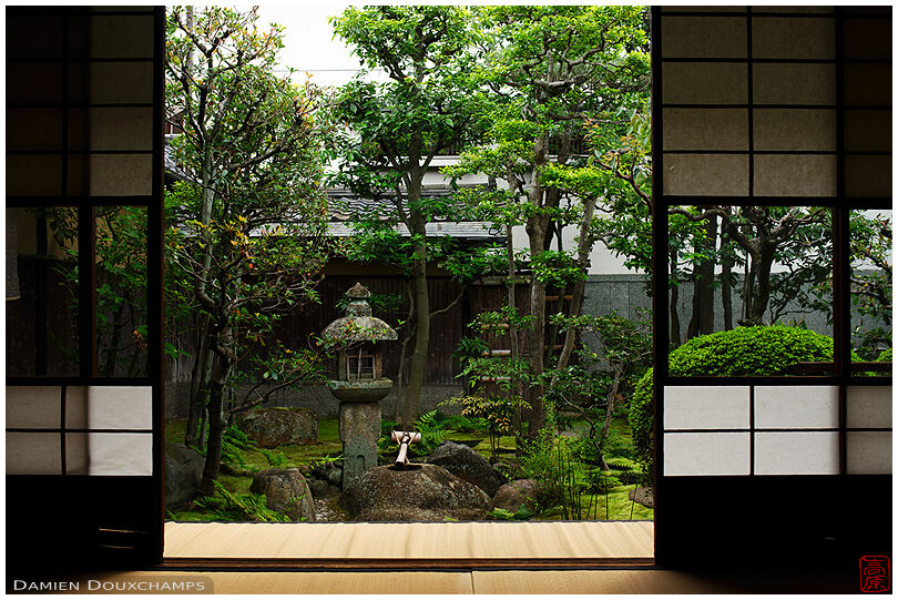 Tsukubai water basin and stone lantern in the garden of the Rakutoihōkan, Kyoto, Japan