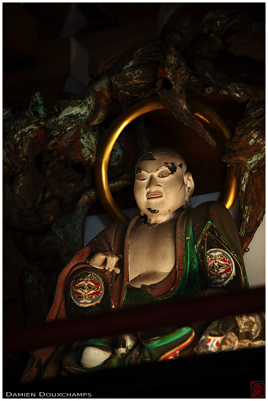 Old derelict Buddhist statue in the mountain temple of Joshoko-ji, Kyoto, Japan