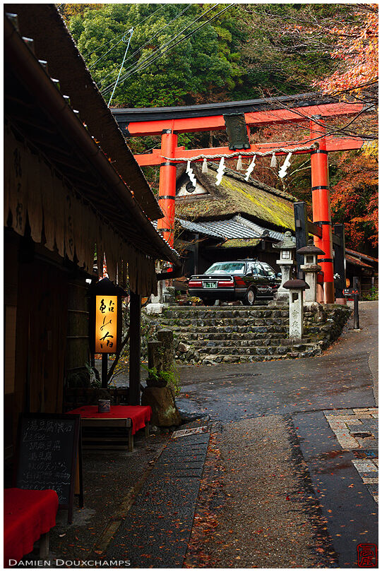 Old store, taxi and red torii gate: a glassic photograph of the northern of Arashiyama, Kyoto, Japan