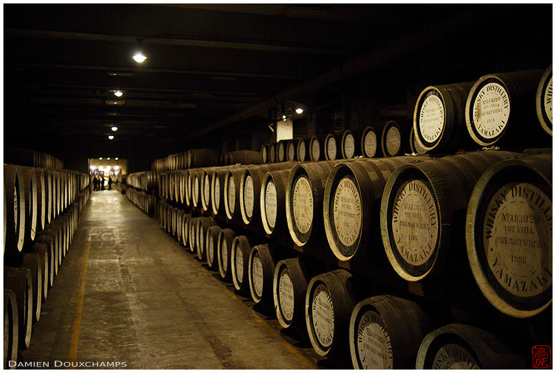 Whiskey ageing room filled with wooden barrels in the Yamazaki distillery, Osaka, Japan