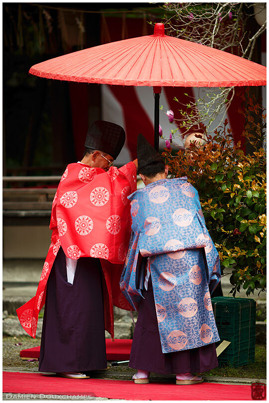 Officials setting up a traditional umbrella in Munakata-jinja, Kyoto, Japan