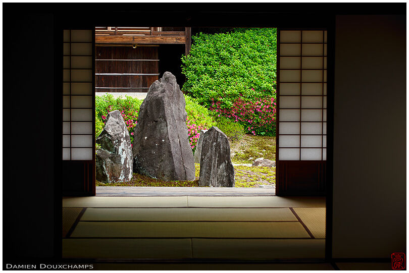 Standing stone and early rhododendron season as seen across the tatami rooms in Komyo-in temple, Kyoto, Japan