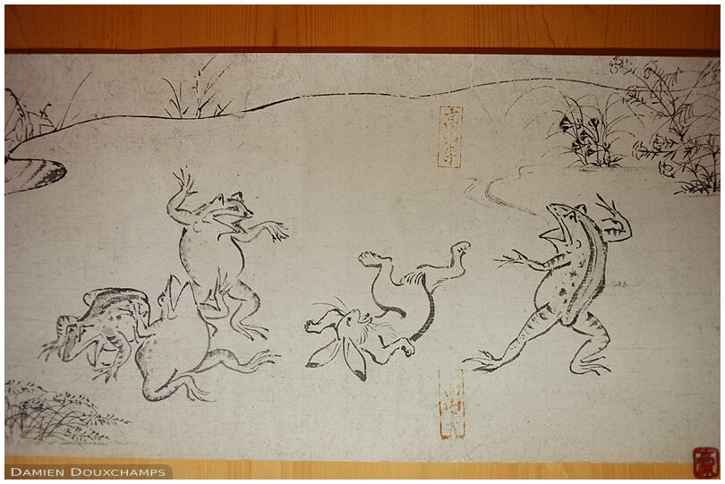 Old humorous scroll depicting frolicking frogs in Kōzan-ji temple, Kyoto, Japan