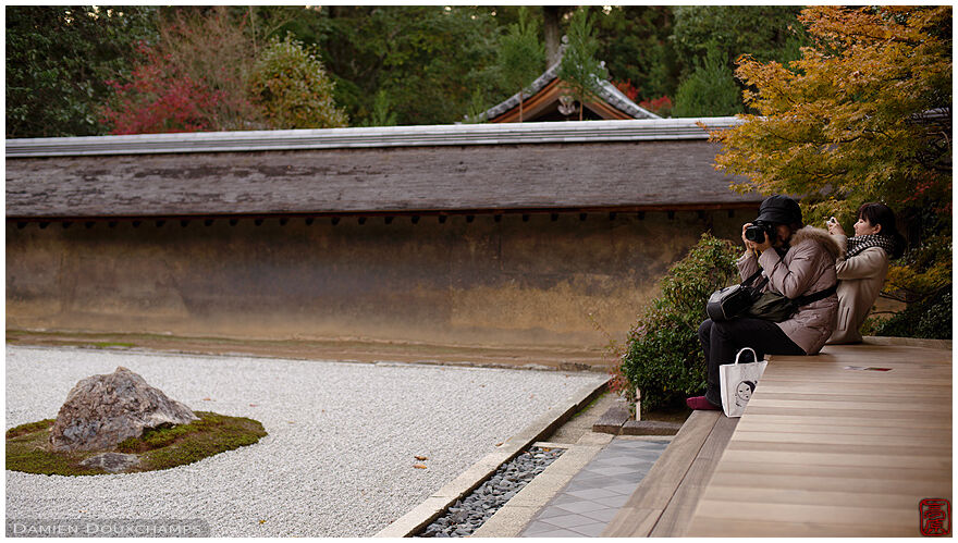 Two women photographing the rock garden of Ryoan-ji temple, Kyoto, Japan