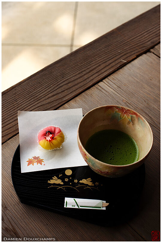 Tea and sweet on a lovely platter decorated with cute rabbit gold painting in Nanyo-in temple, Kyoto, Japan