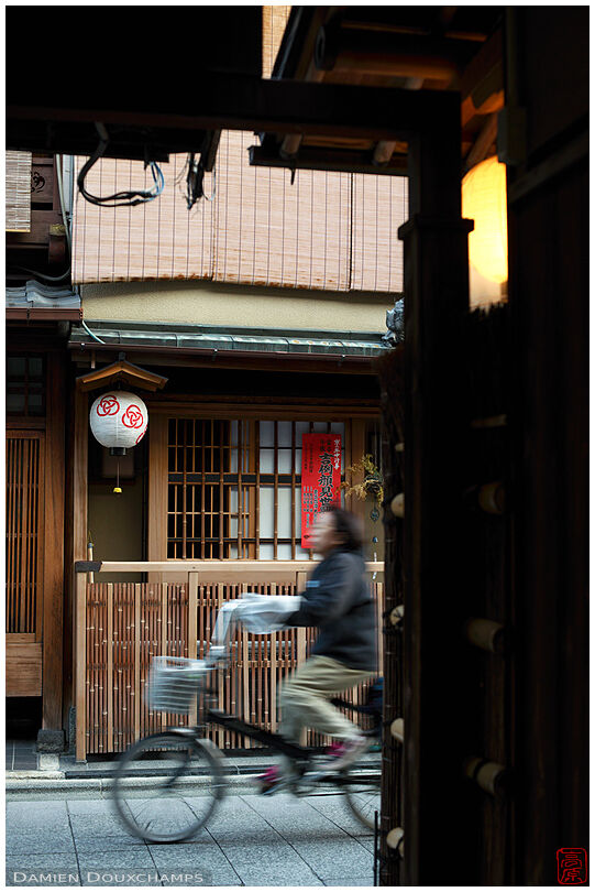 Cycling in the geisha district of Miyagawacho, Kyoto, Japan