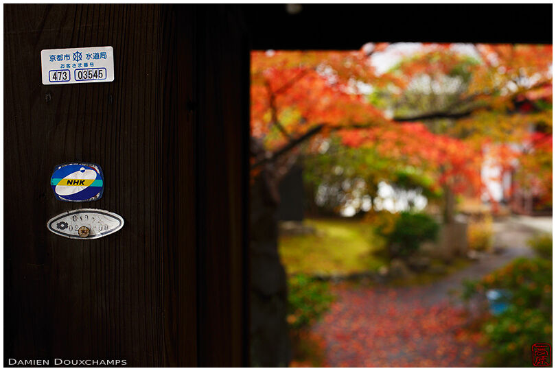 Utilities stickers on the gate of Shōkaku-ji temple, Kyoto, Japan