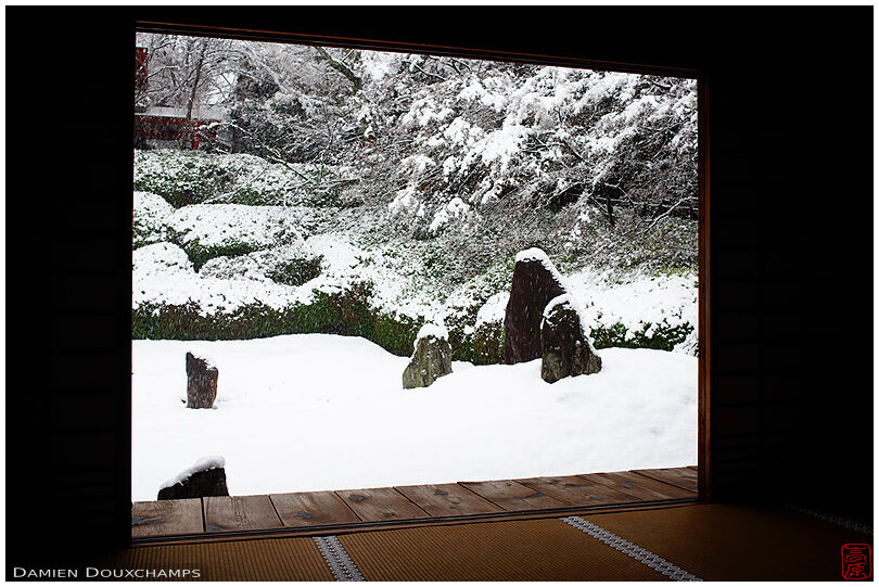 Standing stones protruding from snow covered rock garden, Komyo-in temple, Kyoto, Japan