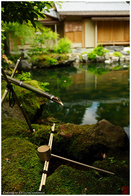 Tsukubai water basin with ladle near a tea house of the Hakusa sonso villa, Kyoto, Japan