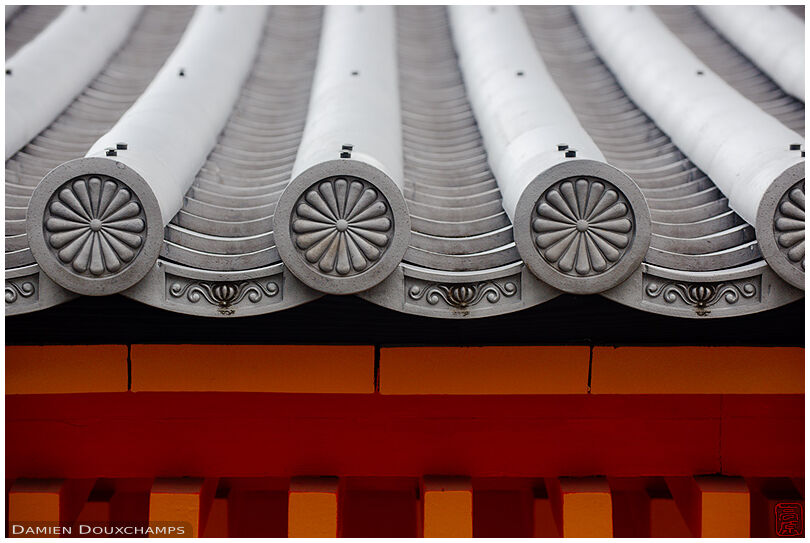 Imperial flower detail on the roof tiles of the imperial palace, Kyoto, Japan