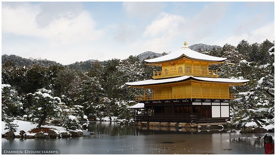The snow-covered Golden Pavilion and its frozen pond, Rokuon-ji temple, Kyoto