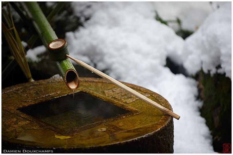 Tsukubai with bamboo ladle in winter, Ryoan-ji temple, Kyoto, Japan