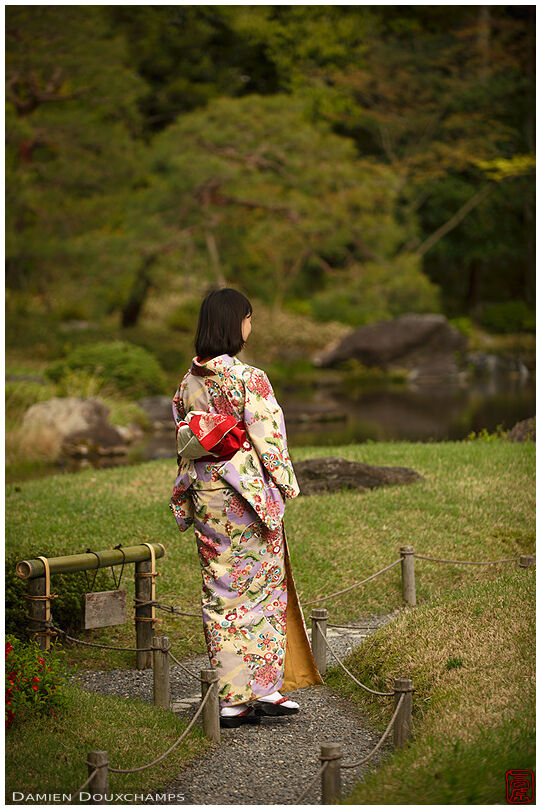 Lady wearing kimono strolling in the garden of Murin-an, Kyoto, Japan