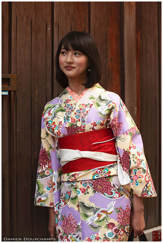Young lady wearing a kimono in the old streets of Kyoto, Japan