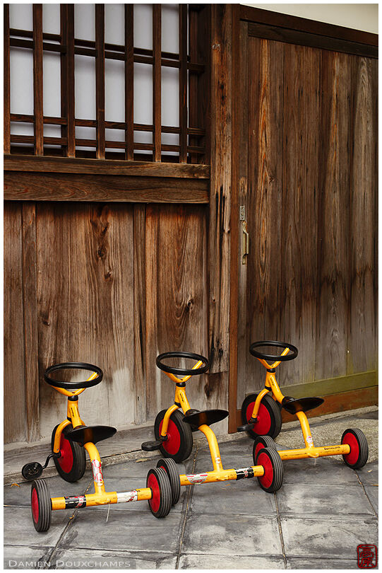 Three small tricycles on the grounds of Shakuzo-ji temple, Kyoto, Japan