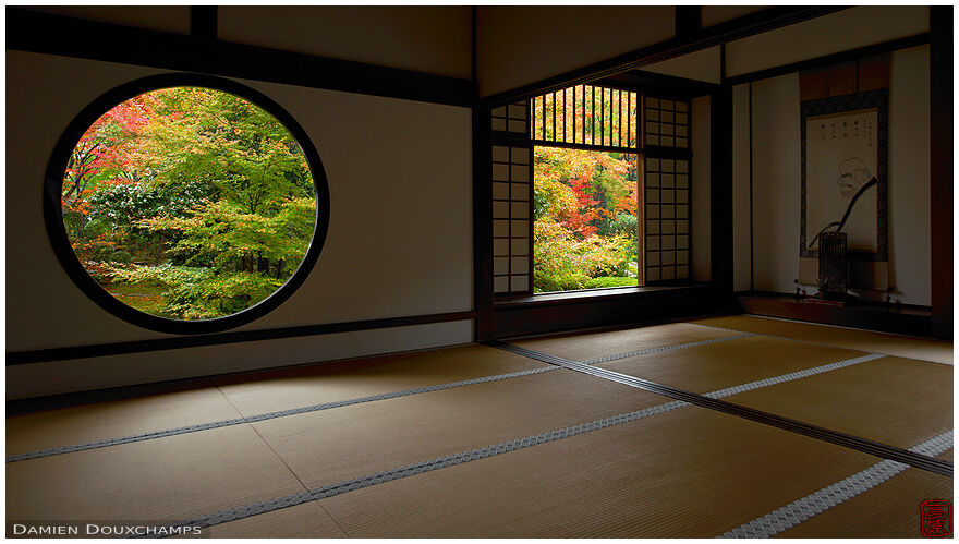 Autumn colours through the round window of enlightenment, Genko-an temple, Kyoto, Japan