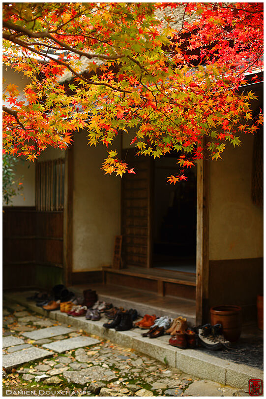 Numerous shoes waiting for their visiting owners at the entrance of Jikishi-an temple, Kyoto, Japan
