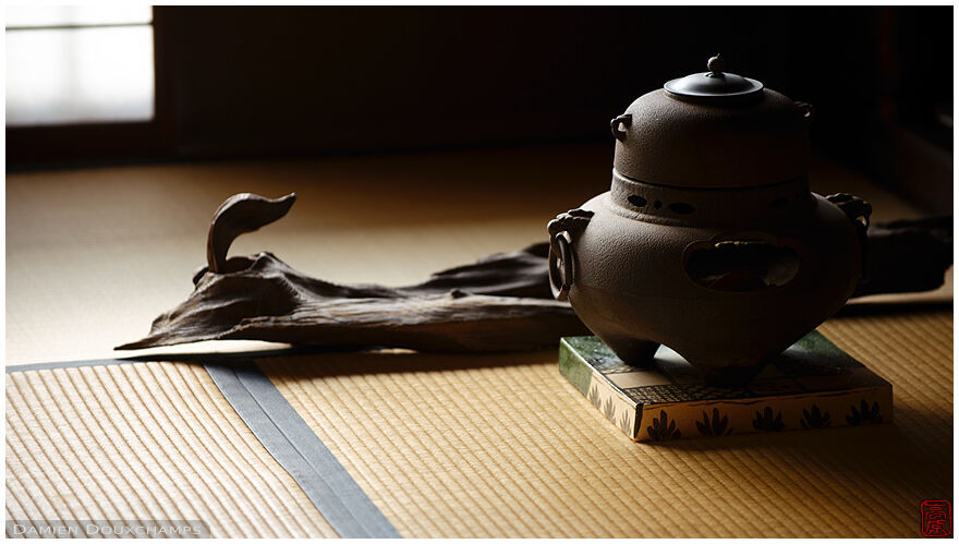 Tea pot and duck-shaped piece of wood on the tatami floor of a tea room in Nobotoke-an, Kyoto, Japan