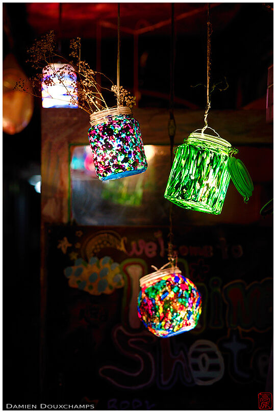 Painted glass pots as lanterns at the entrance of a small bar in a dark side alley of Pontocho, Kyoto, Japan