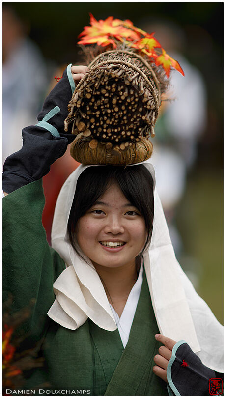 Woman from Ohara carrying wood on her head during the Jidai festival in the Imperial palace of Kyoto, Japan