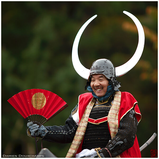 Laughing mounted warrior with oversized helmet ornaments during the Jidai festival, Kyoto, Japan