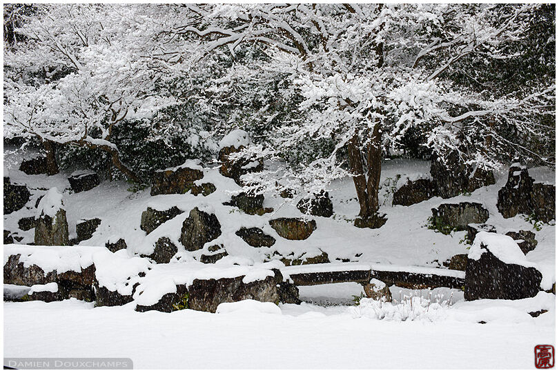 Snow covered zen garden with only stone bridge visible, Entoku-in temple, Kyoto, Japan