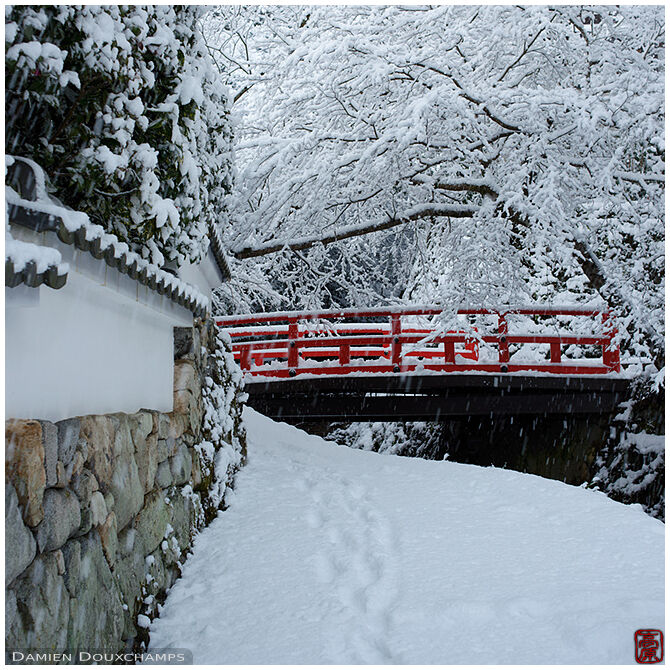 Red bridge in snowscape near Jikko-in temple, Kyoto, Japan