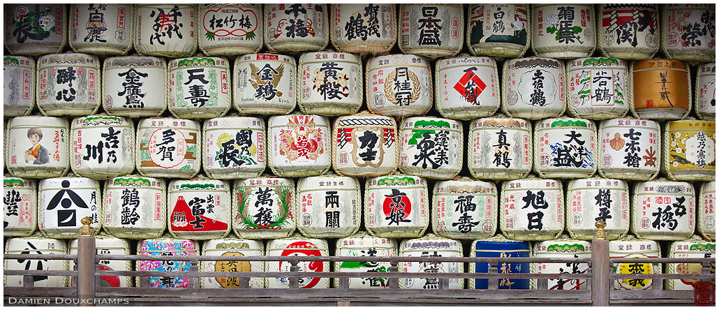 Large long wall of sake barrels offerings in Matsuo-taisha shrine, Kyoto, Japan
