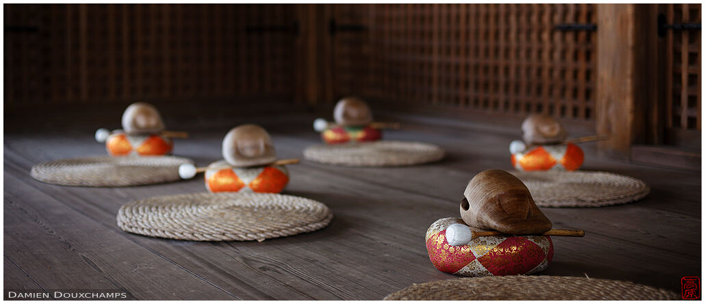 Cushions and wooden bells in a prayer hall of Chion-in temple, Kyoto, Japan