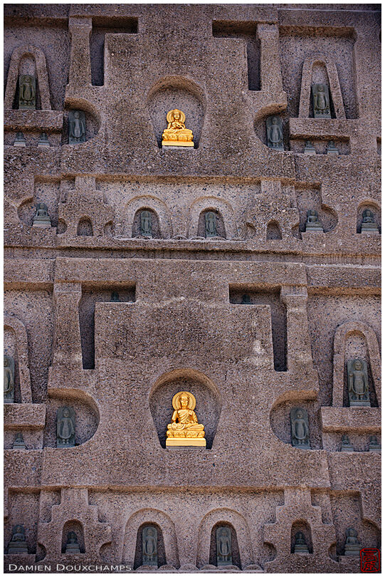 Gold and black Buddha statues on the tower of Myoman-ji temple, Kyoto, Japan