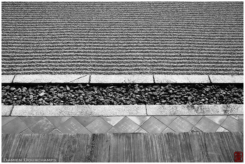 Layers of a rock garden: wooden terrace, tiled pavement, rough rain collecting gravel gutter and raked sand, Tokai-in temple, Kyoto, Japan