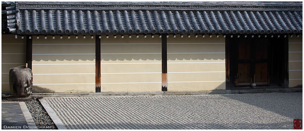 Tsukubai water basin with drying ladle in the large and simple rock garden of Tokai-in temple, Kyoto, Japan