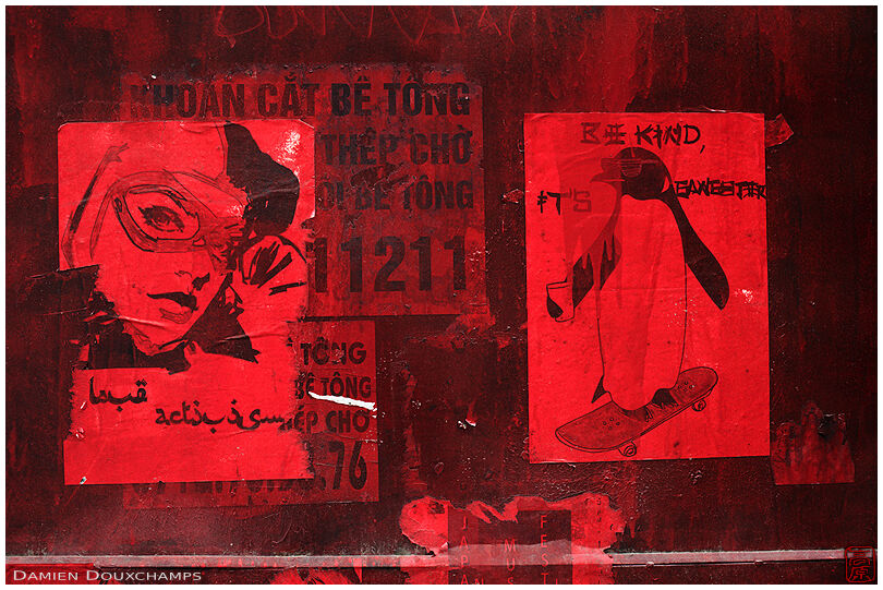 Bright red posters on old steel door in Hanoi, Viet Nam